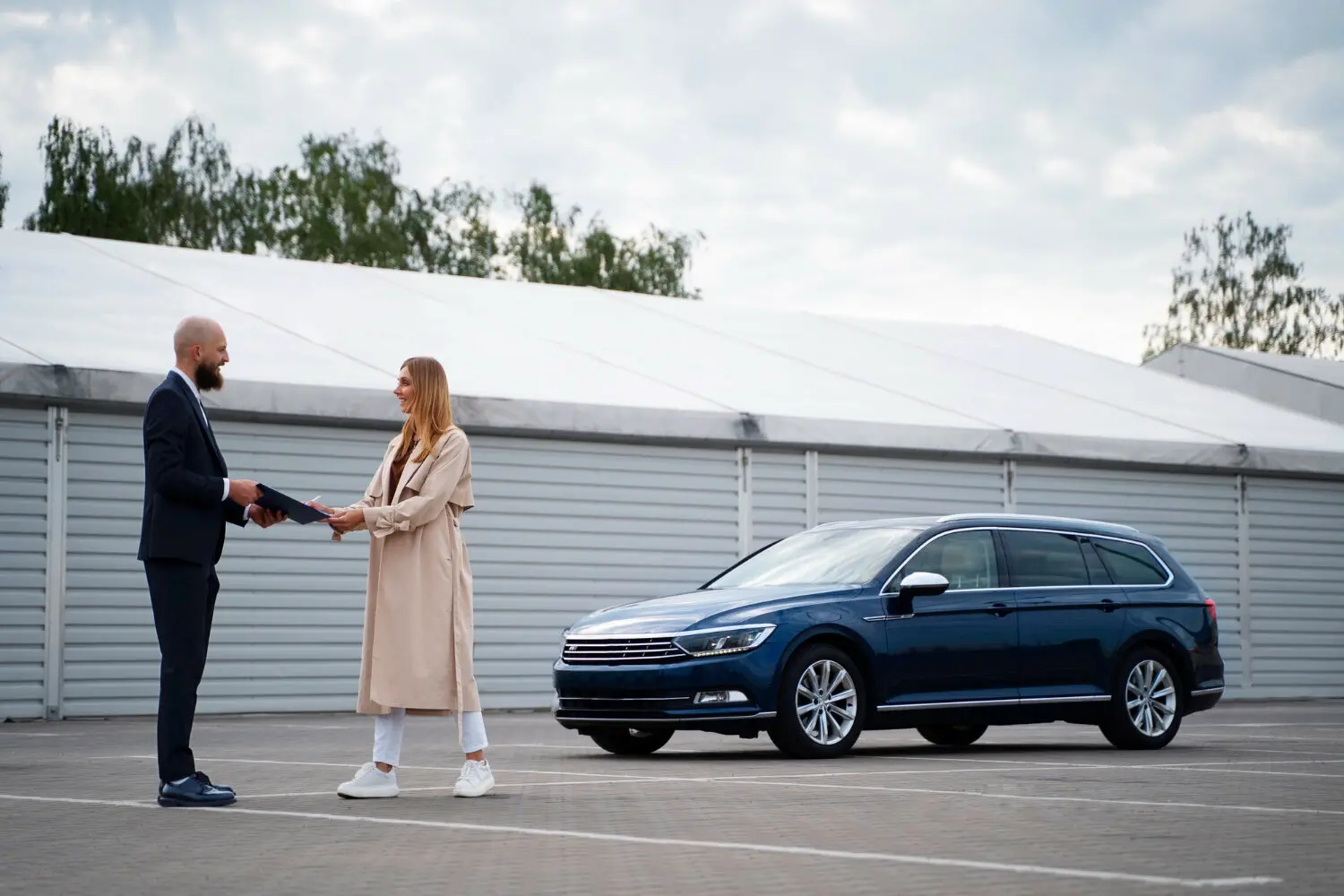 Man and woman closing a deal in car sales